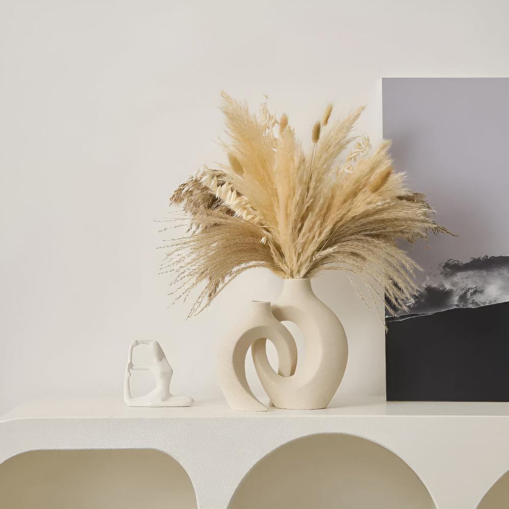 Duo of matte ceramic vases, intertwined abstract shapes