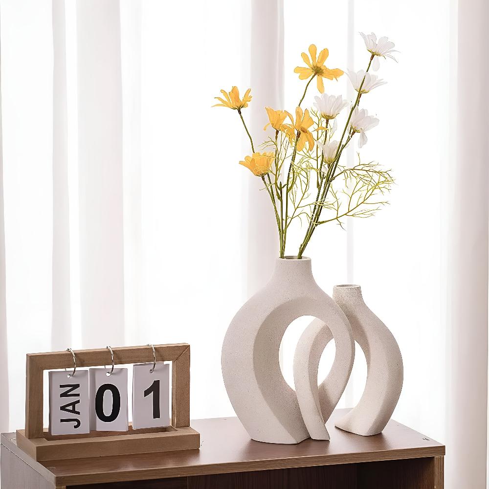 Duo of matte ceramic vases, intertwined abstract shapes