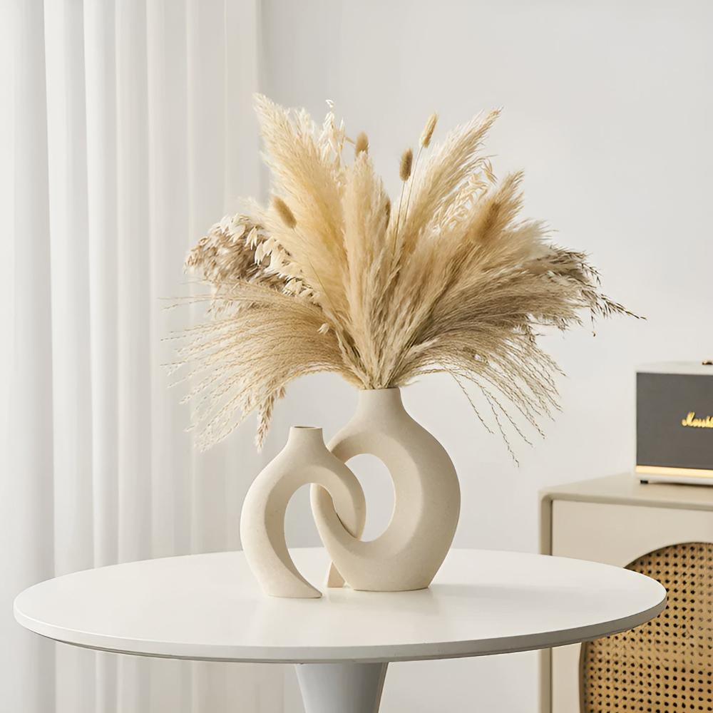 Duo of matte ceramic vases, intertwined abstract shapes