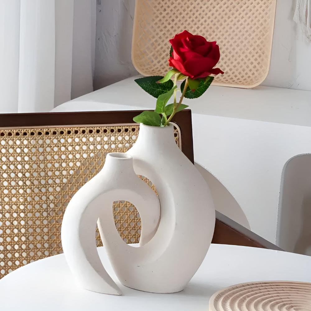 Duo of matte ceramic vases, intertwined abstract shapes