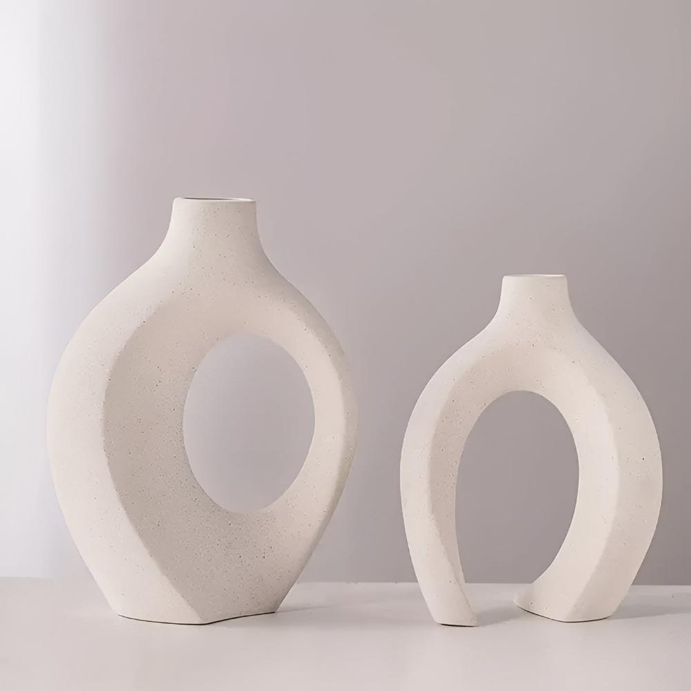 Duo of matte ceramic vases, intertwined abstract shapes