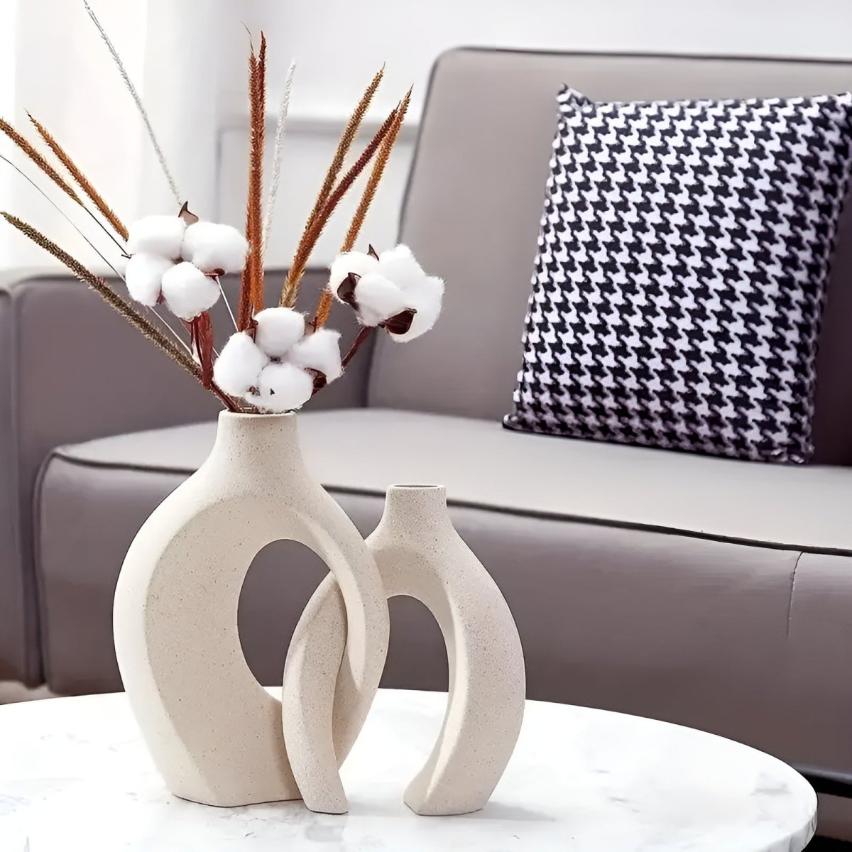 Duo of matte ceramic vases, intertwined abstract shapes