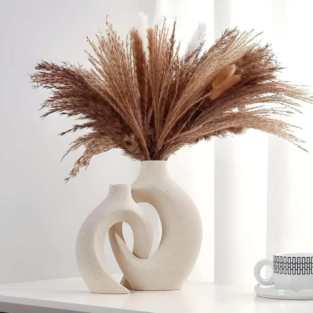 Duo of matte ceramic vases, intertwined abstract shapes