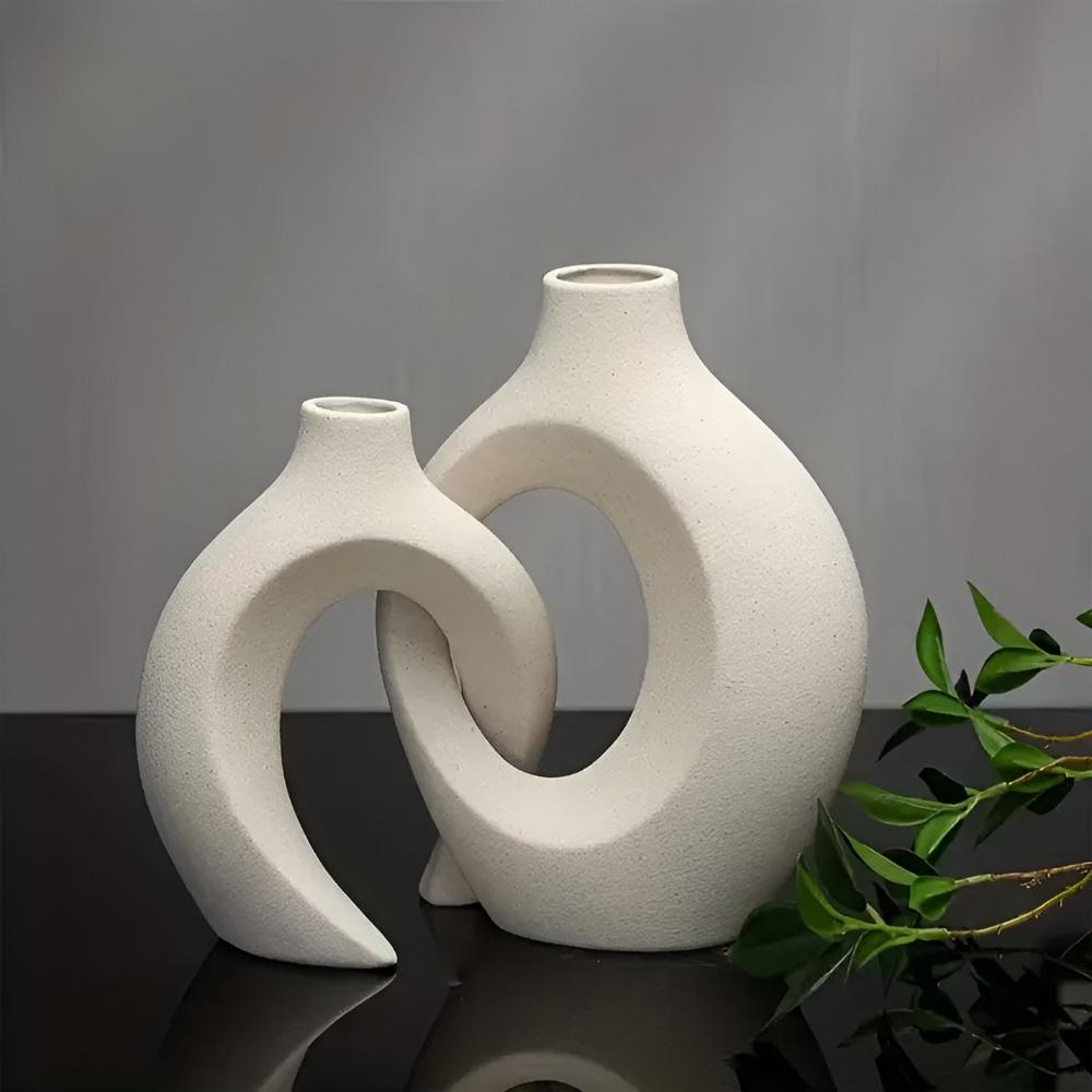 Duo of matte ceramic vases, intertwined abstract shapes