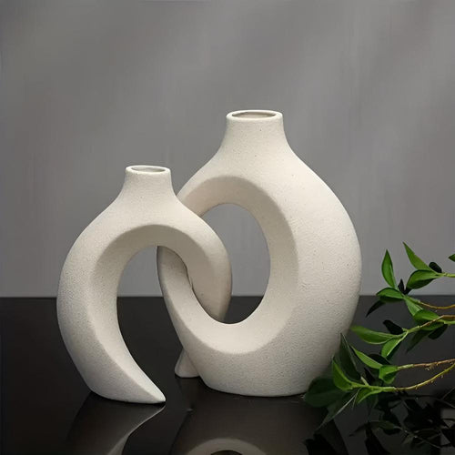 Duo of matte ceramic vases, intertwined abstract shapes